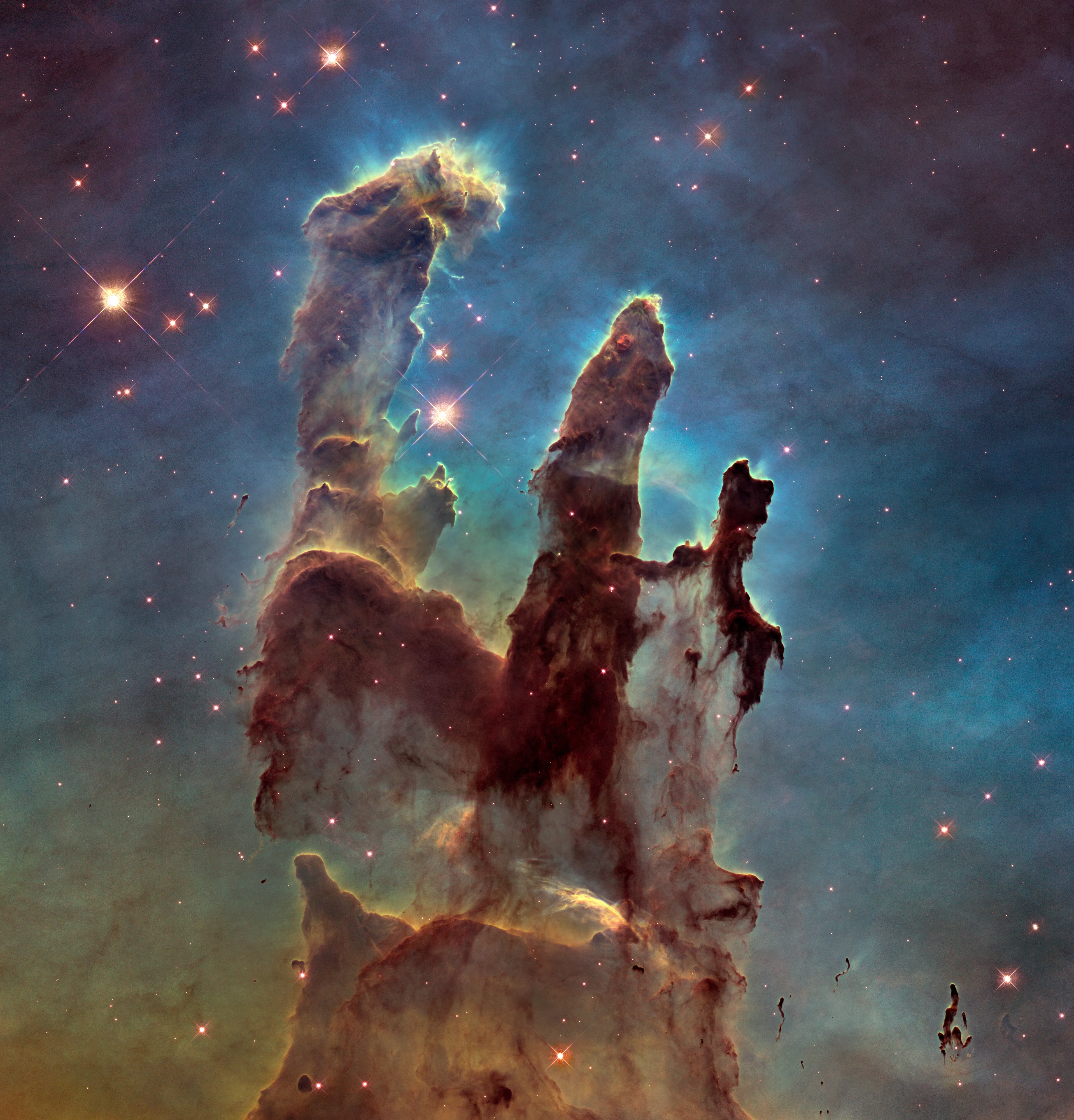 The Pillars of Creation, imaged by the Hubble Space Telescope: towering columns of gas and dust in the Eagle Nebula, where new stars are born.