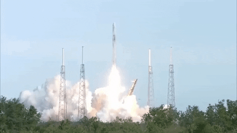 A rocket lifting off from a real launch pad, engine ignition and exhaust smoke.